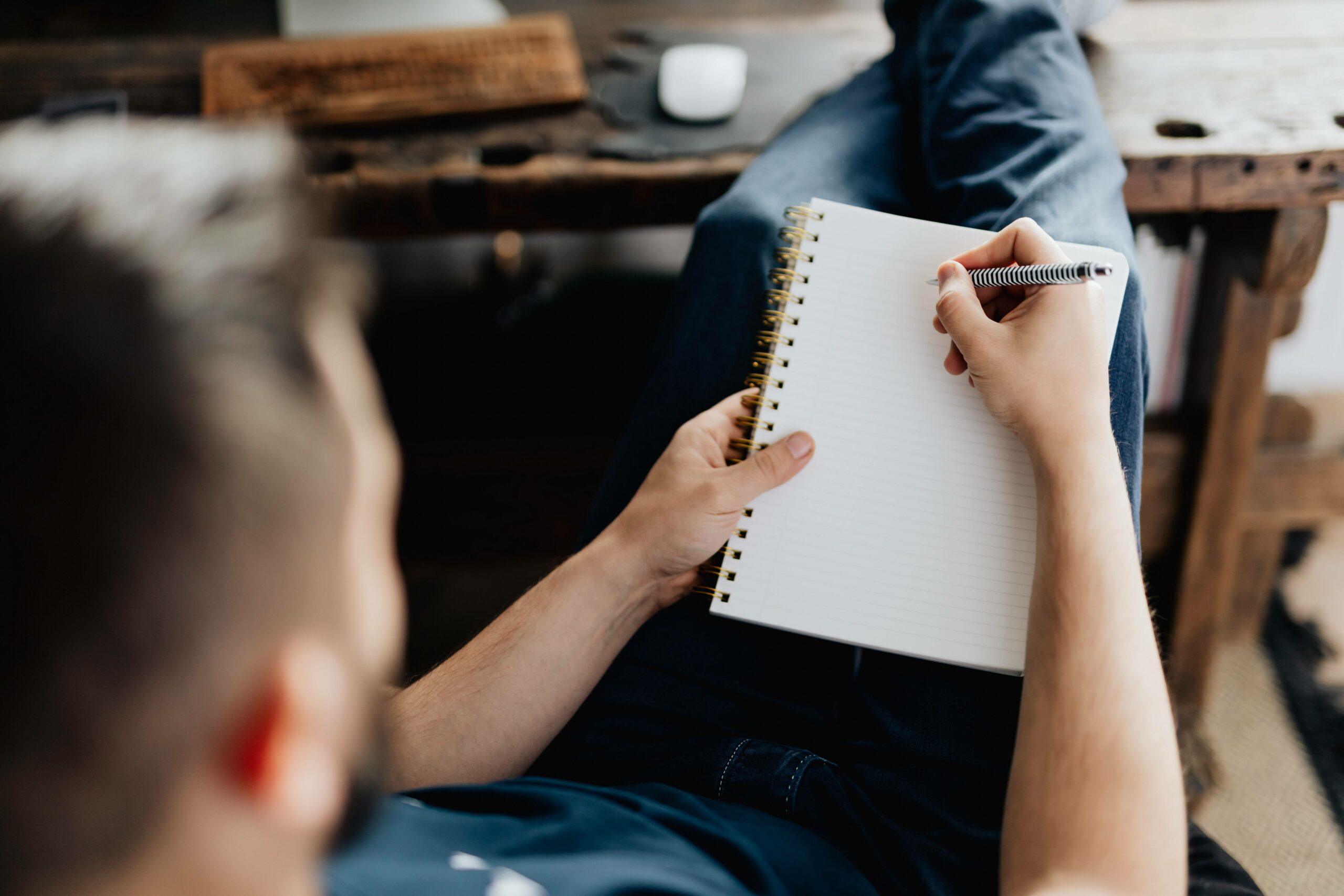 man writing on blank page